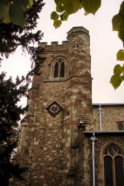 The clock side of the tower of All Saints Church Caddington