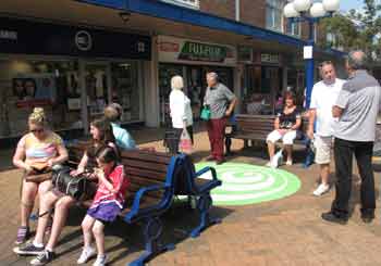 People sitting on benches listening to the soundtracks