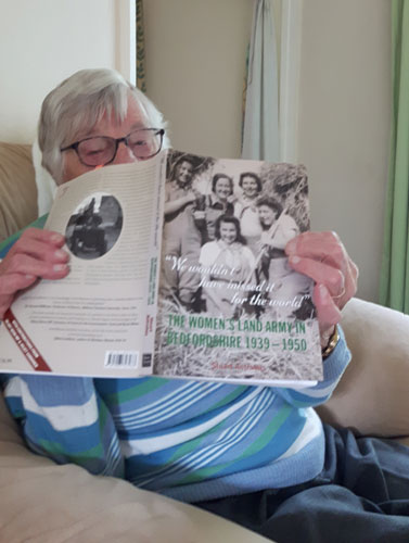 Edith 'Hilda' Nicholson reading Stuart Antrobus's book on the WW2 land girls in Bedfordshire on her 98th birthday. Photo by Helen Archer, her niece