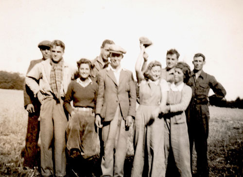 Molly and Nancy Joan Gage in a group with other land girls and workers