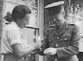 Sharnbrook land girl receiving trophy at the fete from Colonel Part, August 1945
