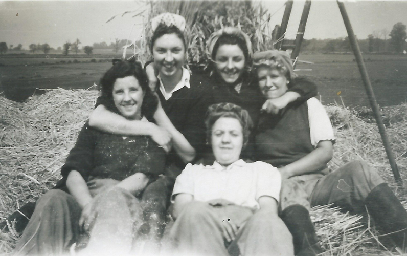 Group of Land Girls after threshing at Tempsford