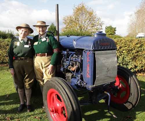 Two former Women's Land Army girls with a tractor at the unveiling of the tribute sculpture