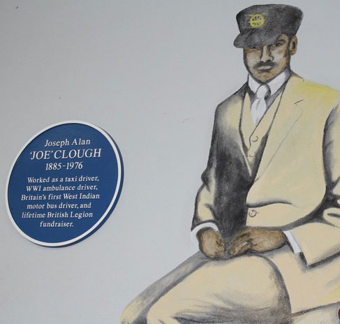Joseph Alan 'Joe' Clough Commemorative Plaque to the left of a mural portrait of Joe in a bus driver's uniform