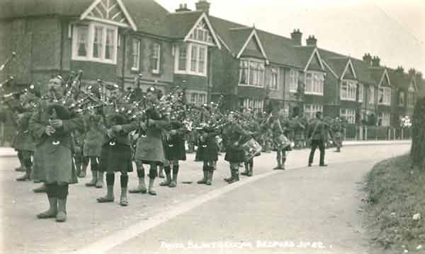 Pipes and drums of a battalion of the Argyll and Sutherland Highlanders at the junction of Shaftesbury Avenue and Kingsley Road