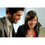 A man and a woman looking at a computer together