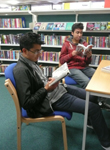 Two boys reading in the library