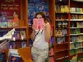 Girl hiding behind book